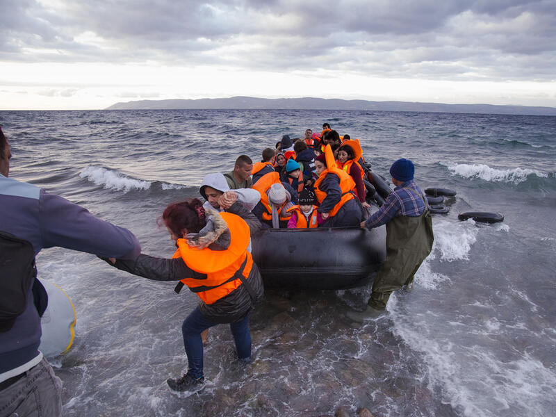 Syrian migrants / refugees arrive from Turkey on boat through sea with cold water near Molyvos, Lesbos. (Shutterstock/ File Photo)