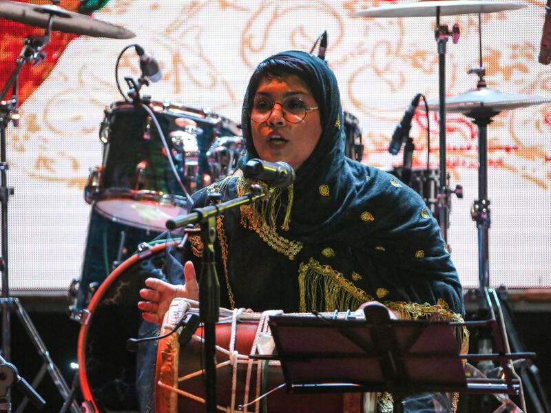 Faezeh Mohseni, drummer of the Iranian all-women music band "Dingo" performs with other band members at a concert during the state-organised "Persian Gulf music" festival at Avini Hall in Iran's southern Gulf port city of Bandar Abbas on April 29, 2019. ATTA KENARE / AFP
