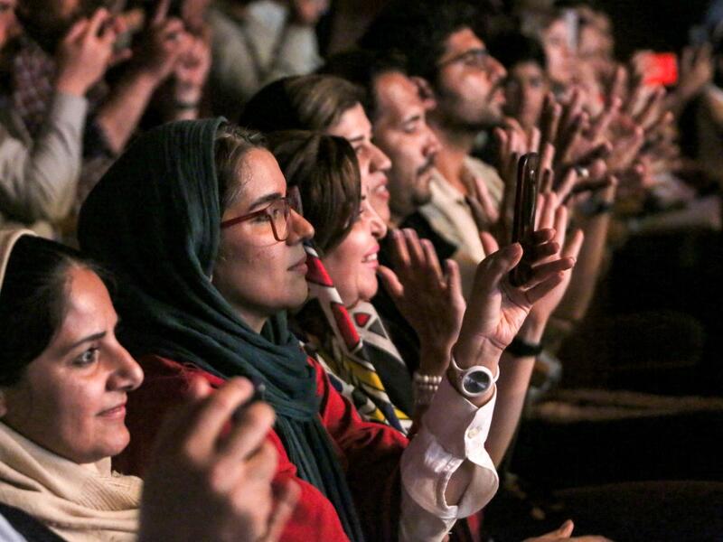 Women audience members applaud as they attend a performance by the Iranian all-women music band "Dingo" during the state-organised "Persian Gulf music" festival at Avini Hall in Iran's southern Gulf port city of Bandar Abbas on April 29, 2019.ATTA KENARE / AFP