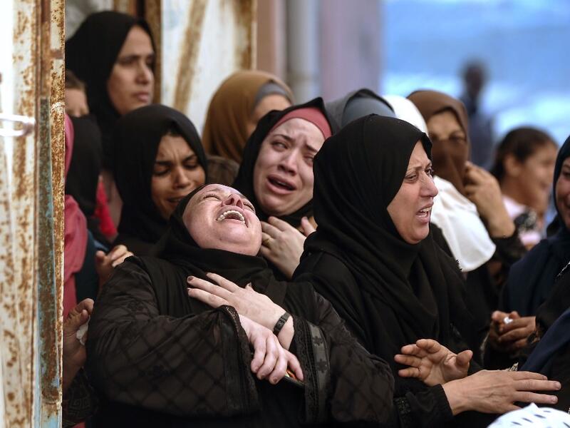 Palestinian women mourn during the funeral of three children who were killed in a fire ignited by a candle used to light up their room during a power cut in al-Nusirat refugee camp in the central Gaza Strip on September 2, 2020.MAHMUD HAMS / AFP