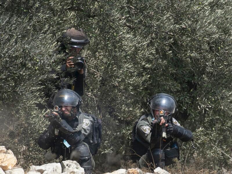 A member of the Israeli security forces fires a rubber bullet towards Palestinian protesters during clashes with Israeli security forces following a demonstration to protest Israel's plan to annex parts of the occupied West Bank, in the village of Kfar Qaddum, on September 4 2020. JAAFAR ASHTIYEH / AFP