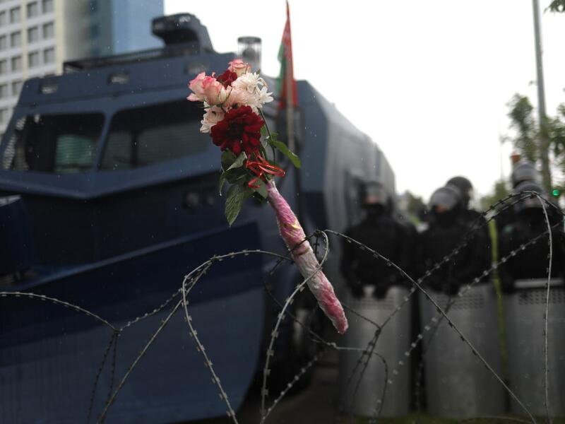 Flowers attached to a barbed wire fence during a rally to protest against the disputed August 9 presidential elections results in Minsk on September 6, 2020. Tens of thousands of Belarusians staged a peaceful new march on September 6, keeping the pressure on strongman Alexander Lukashenko who has refused to quit after his disputed re-election and turned to Russia for help to stay in power. TUT.BY / AFP