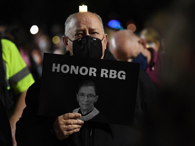 People pay their respects to Ruth Bader Ginsburg near the US Supreme Court in Washington, DC on September 19, 2020. US President Donald Trump vowed to quickly nominate a successor, likely a woman, to replace late Supreme Court Justice Ruth Bader Ginsburg, only a day after the death of the liberal stalwart. Eric BARADAT / AFP