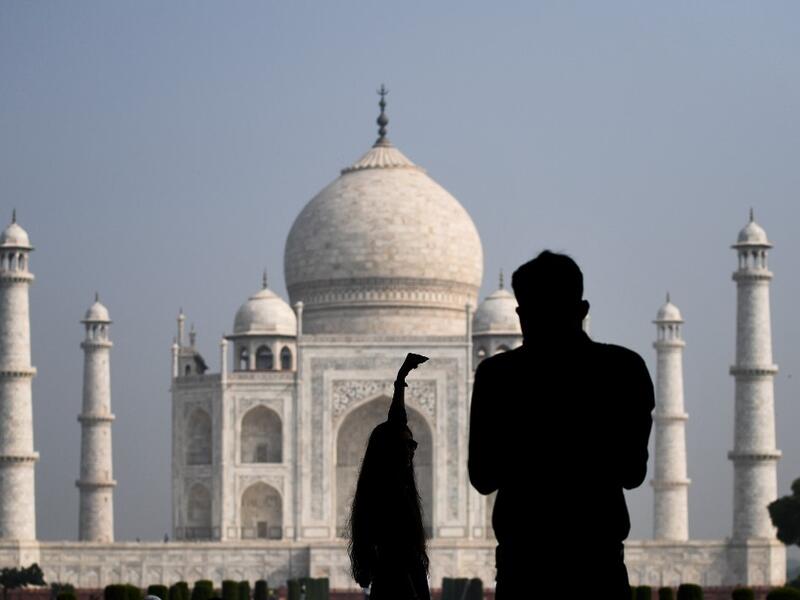 Tourists take pictures as the visit the Taj Mahal in Agra on September 21, 2020. The Taj Mahal reopened to visitors on September 21 in a symbolic business-as-usual gesture even as India looks set to overtake the US as the global leader in coronavirus infections. Sajjad HUSSAIN / AFP