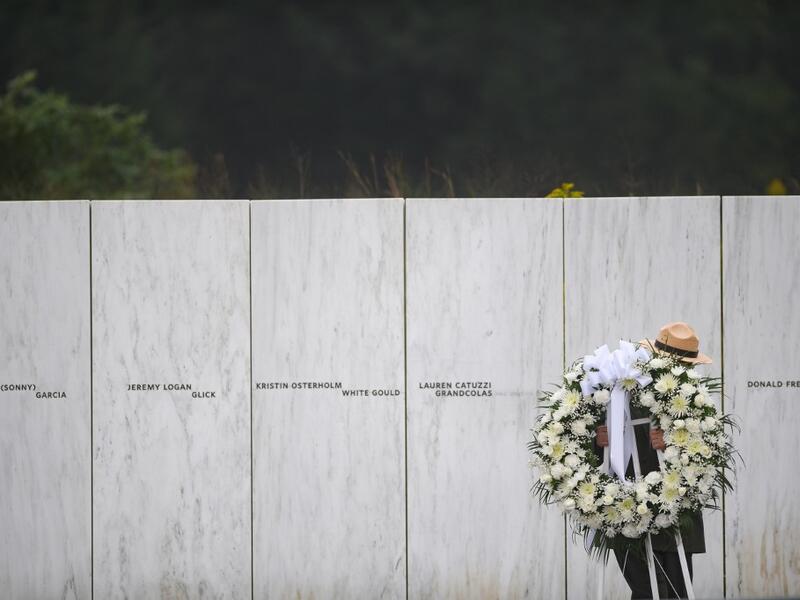 A US Park Ranger moves a memorial wreath prior to President Donald J. Trump delivering remarks at the Flight 93 National Memorial commemorating the 17th Anniversary of the crash of Flight 93 and the September 11th terrorist attacks on September 11, 2020 in Shanksville, Pennsylvania. The nation is marking the nineteenth anniversary of the terror attacks of September 11, 2001, when the terrorist group al-Qaeda flew hijacked airplanes into the World Trade Center and the Pentagon, killing nearly 3,000 people. J