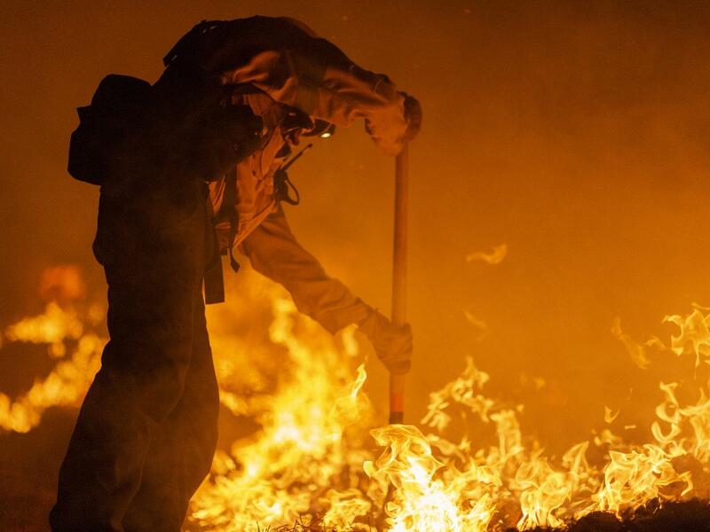 Los Angeles County firefighters, using only hand tools, keep fire from jumping a fire break at the Bobcat Fire in the Angeles National Forest on September 11, 2020 north of Monrovia, California. California wildfires that have already incinerated a record 2.3 million acres this year and are expected to continue till December. The Bobcat Fire has grown to more than 26,000 acres. David McNew/Getty Images/AFP DAVID MCNEW / GETTY IMAGES NORTH AMERICA / Getty Images via AFP