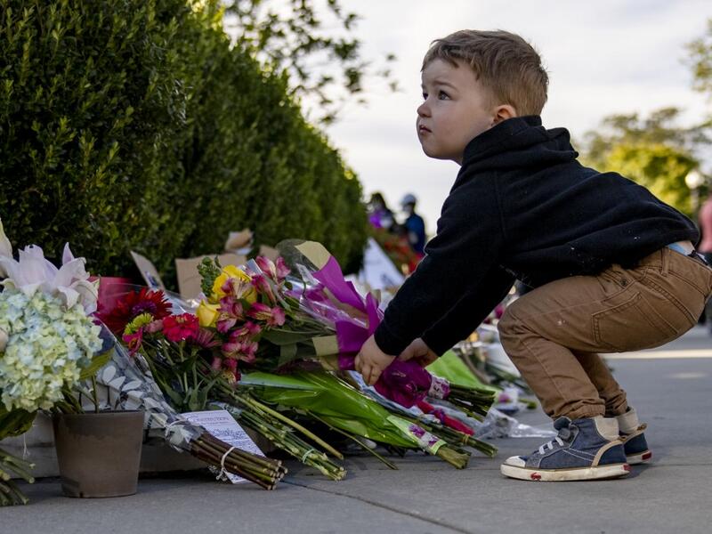 A young boy places flowers at a makeshift memorial in honor of Supreme Court Justice Ruth Bader Ginsburg in front of the US Supreme Court on September 19, 2020 in Washington, DC. Justice Ginsburg has died at age 87 after a battle with pancreatic cancer. Samuel Corum/Getty Images/AFP Samuel Corum / GETTY IMAGES NORTH AMERICA / Getty Images via AFP
