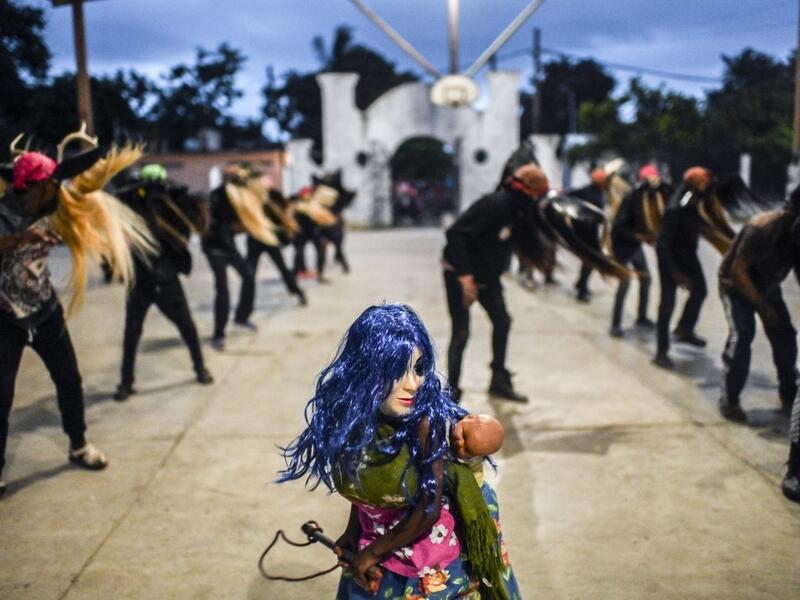 Teenagers, members of the Afro-Mexican community, make Los Diablos dance, at El Pitayo community in Cuajinicuilapa, Guerrero state, Mexico, on September 10, 2020, amid the COVID-19 coronavirus pandemic. Although there are 1,5 million African descendants in a country of 128 million inhabitants, it is normal to hear that "in Mexico there are no blacks". PEDRO PARDO / AFP