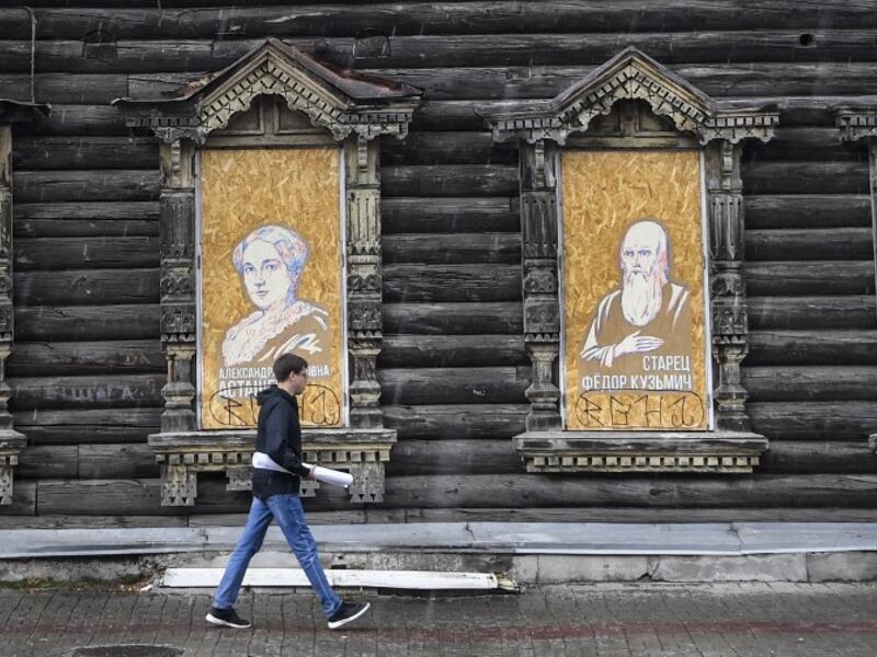 A man walks past a traditional wooden house in the Siberian city of Tomsk on September 8, 2020. Tomsk is considered to be one of the oldest towns in Siberia founded in 1604. Wooden architecture is one of the symbols of the city of Tomsk, its distinctive feature. Today Tomsk is the only city in Siberia where the background wooden buildings have been preserved, reflecting the manor structure of the city streets. Unfortunately, many wooden houses are not in very good condition and require restoration. Alexande