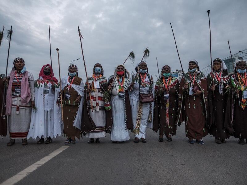 Women, wearing traditional clothing, sing and march during the celebration of “Irreechaa”, the Oromo people thanksgiving holiday, in Addis Ababa, Ethiopia, on October 3, 2020.  EDUARDO SOTERAS / AFP