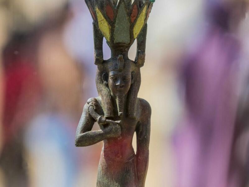 A picture taken on October 3, 2020 shows a statue, excavated by the Egyptian archaeological mission which resulted in the discovery of a deep burial well with more than 59 human coffins closed for more than 2,500 years, displayed during a press conference at the Saqqara necropolis, 30 kms south of the Egyptian capital Cairo. They were unearthed south of Cairo in the sprawling burial ground of Saqqara, the necropolis of the ancient Egyptian capital of Memphis, a UNESCO World Heritage site. Their exteriors ar