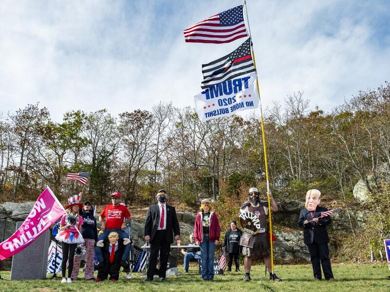 People dressed in political costumes participate in a contest during a Trump campaign rally named "Trumptoberfest" at Rocky Point Park in Warwick, Rhode Island on October 11, 2020. Many supporters dressed in political campaign clothing and waved flags while others dressed in festive costumes to take part in a political costume contest. Joseph Prezioso / AFP