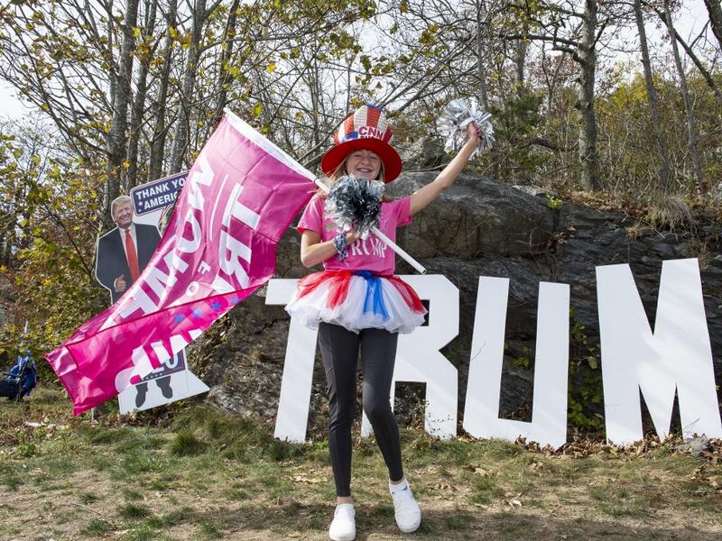 People dressed in political costumes participate in a contest during a Trump campaign rally named "Trumptoberfest" at Rocky Point Park in Warwick, Rhode Island on October 11, 2020. Many supporters dressed in political campaign clothing and waved flags while others dressed in festive costumes to take part in a political costume contest. Joseph Prezioso / AFP
