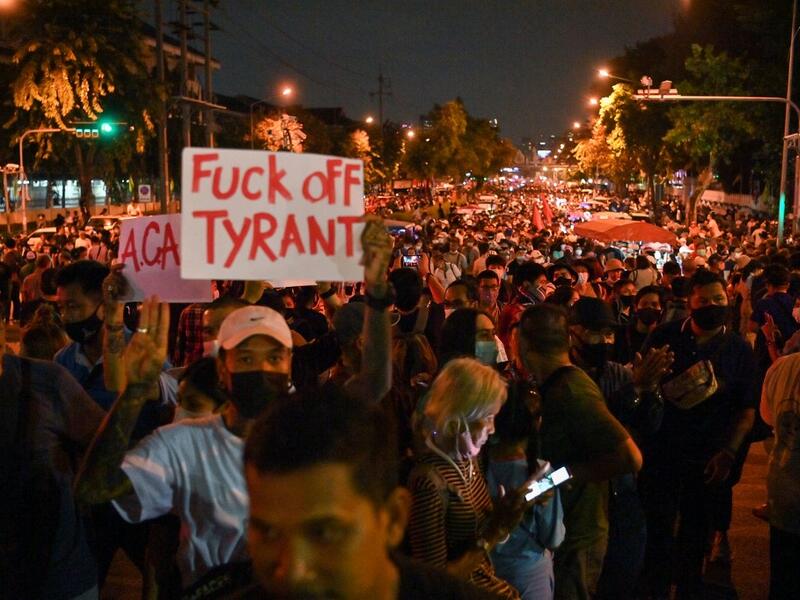 A pro-democracy protester holds up a sign during an anti-government rally next to Government House in Bangkok on October 14, 2020. Mladen ANTONOV / AFP