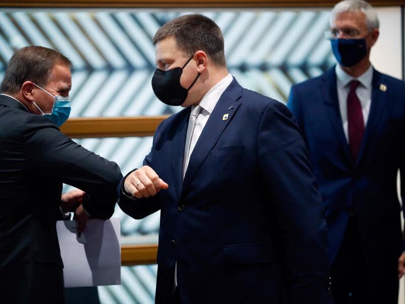 Sweden's Prime Minister Stefan Lofven (L) greets Estonia's Prime Minister Juri Ratas (C) with an elbow bump next to Latvia's Prime Minister Arturs Krisjanis Karins prior a North Baltic countries meeting on the sidelines of a two days European Union (EU) summit at the European Council Building in Brussels, on October 15, 2020. (AFP/File)