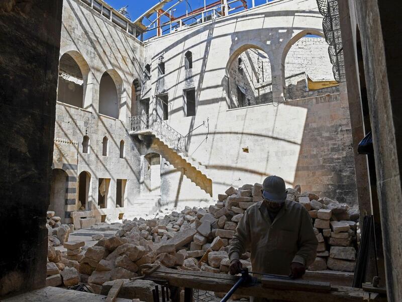 Syrian workers take part in the reconstruction of Martini restaurant and hotel in the Jdaideh neighbourhood in Aleppo's Old City on October 17, 2020. AFP