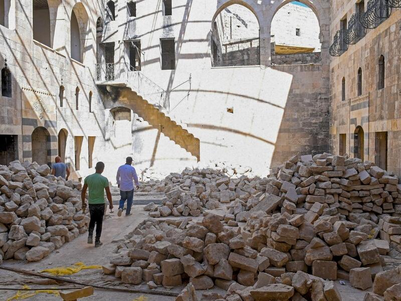 Syrian workers take part in the reconstruction of Martini restaurant and hotel in the Jdaideh neighbourhood in Aleppo's Old City on October 17, 2020. AFP