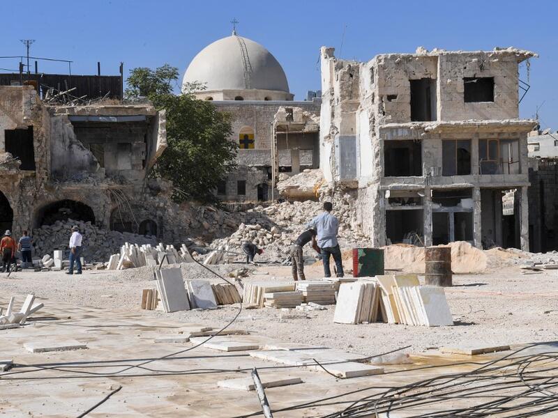 Syrian workers take part in the reconstruction of the Hatab Square in the Jdaideh neighbourhood in Aleppo's Old City on October 17, 2020. AFP