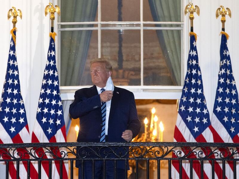  President Donald Trump removes his mask upon return to the White House from Walter Reed National Military Medical Center on October 05, 2020 in Washington, DC. Trump spent three days hospitalized for coronavirus. Win McNamee/Getty Images/AFP WIN MCNAMEE / GETTY IMAGES NORTH AMERICA / Getty Images via AFP