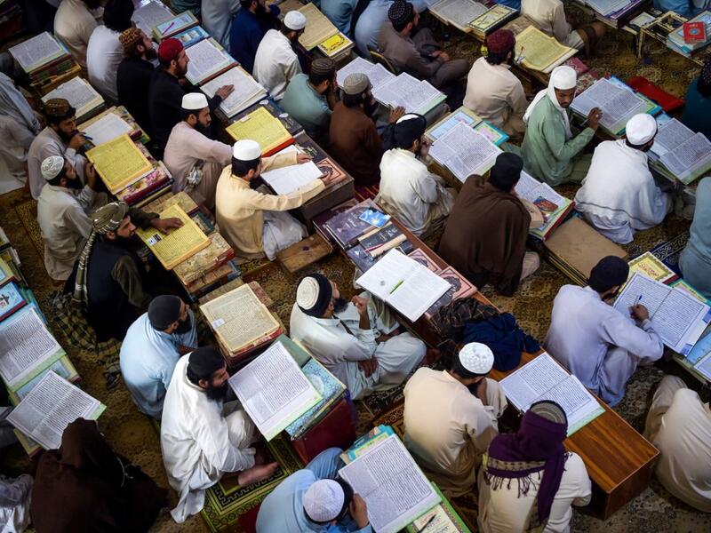 AFP Photo DOCUMENT REFERENCE000_8TL4C7 SLUGPAKISTAN - AFGHANISTAN - CONFLICT - ISLAM CREATION DATE10/19/2020 CITY/COUNTRYAKORA KHATTAK, PAKISTAN CREDITABDUL MAJEED / AFP FILE SIZE/PIXELS/DPI46.25 Mb / 4928 x 3280 / 300 dpi SPECIAL INSTRUCTIONSTO GO WITH 'PAKISTAN-AFGHANISTAN-CONFLICT-ISLAM - FOCUS' BY DAVID STOUT PAKISTAN-AFGHANISTAN-CONFLICT-ISLAM In this picture taken on October 19, 2020 Islamic seminary students attend class at the Darul Uloom Haqqania seminary in Akora Khattak. The Darul Uloom Haqqania 