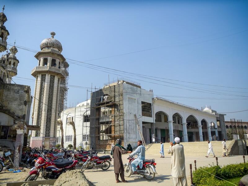 In this picture taken on October 19, 2020 Islamic seminary students stand outside the Darul Uloom Haqqania seminary in Akora Khattak. The Darul Uloom Haqqania seminary has churned out a who's who of Taliban top brass -- including many now on the hardline group's negotiating team holding talks with the Kabul government to end a 20-year war. Abdul MAJEED / AFP
