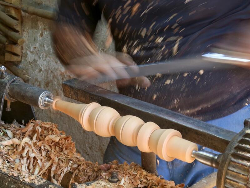 A carpenter shaves a piece of wood to make a narguileh (water pipe) at his workshop in Iraq's central holy city of Karbala on October 21, 2020. The business of strictly gender-separated cafes has carried on, despite the heavy health risks associated with smoking and a full-blown pandemic that has brought an average of 4,000 new coronavirus cases a day to Iraq. Mohammed SAWAF / AFP