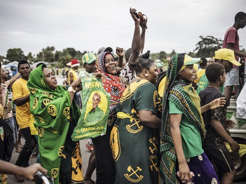Supporters of the ruling Chama Cha Mapinduzi (Revolutionary Party) celebrate the victory of their candidate in the Zanzibar Presidential election on the outskirts of Stone Town, on October 30, 2020. MARCO LONGARI / AFP