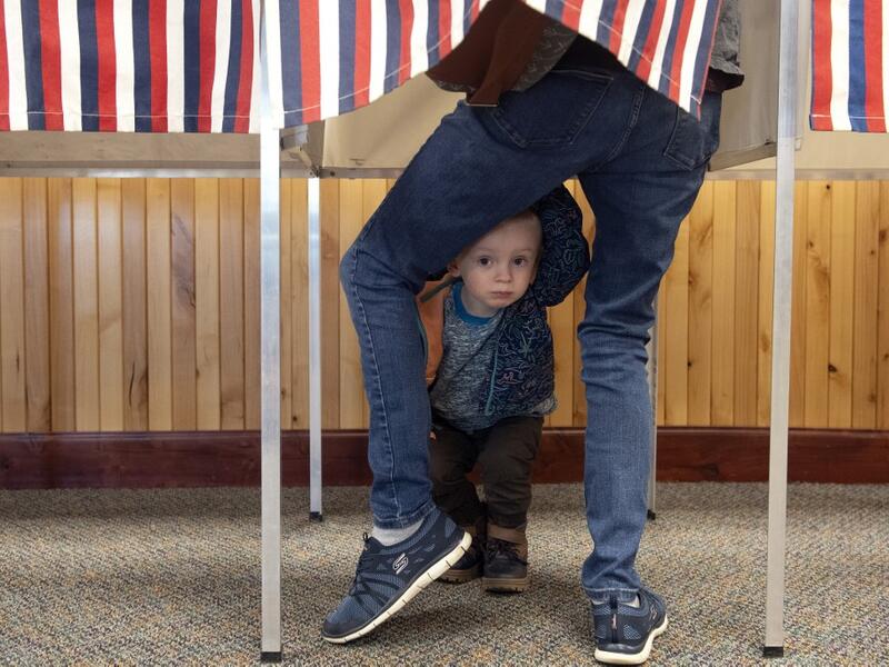 Two-year-old Noah Davenport of Granby, Colorado, waits for his mother to cast her ballot at the Granby Town Hall on November 3, 2020. Americans were voting on Tuesday under the shadow of a surging coronavirus pandemic to decide whether to reelect Republican Donald Trump, one of the most polarizing presidents in US history, or send Democrat Joe Biden to the White House. Jason Connolly / AFP