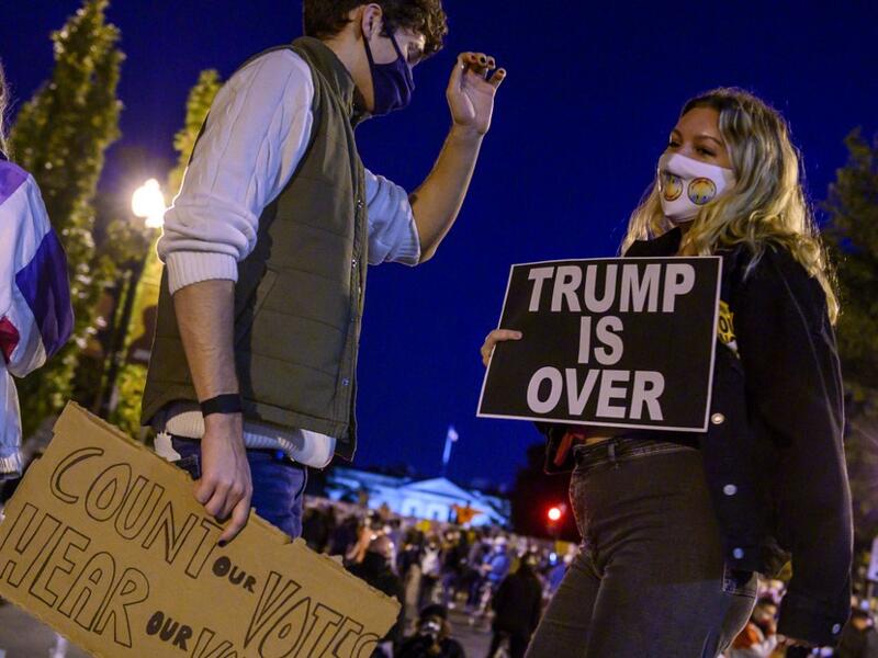 Young activists and Democratic party candidate supporters gather and dance on Black Lives Matter Plaza just outside of the White House (background) on November 4, 2020 in Washington DC. Democrat Joe Biden took a huge step Wednesday to capturing the White House, with wins in Michigan and Wisconsin bringing him close to a majority, but President Donald Trump responded with a diatribe alleging mass fraud and demanding a halt to vote counting. Eric BARADAT / AFP