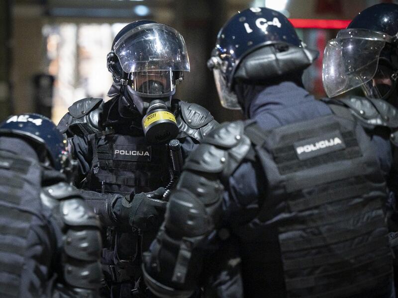 Police officers wear gas masks and anti-riot gear after firing tear gas against protesters as they clash with police during the rally against government’s coronavirus restrictions in Ljubljana on November 5, 2020. Jure Makovec / AFP