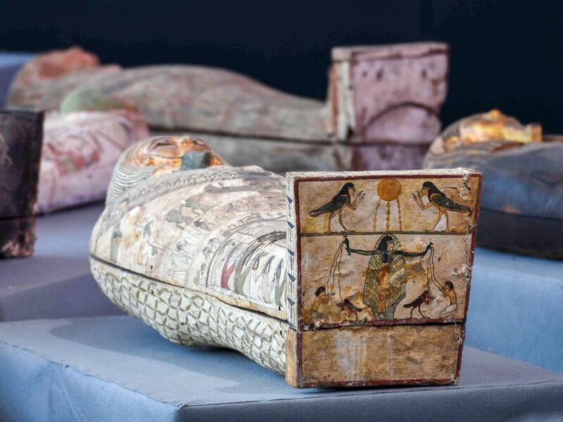 A picture shows wooden sarcophagi during the unveiling of an ancient treasure trove of more than a 100 intact sarcophagi, at the Saqqara necropolis 30 kms south of the Egyptian capital Cairo, on November 14, 2020. Egypt announced the discovery of an ancient treasure trove of more than a 100 intact sarcophagi, the largest such find this year. The sealed wooden coffins, unveiled on site amid fanfare, belonged to top officials of the Late Period and the Ptolemaic period of ancient Egypt. They were found in thr