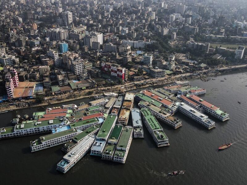 In this aerial photograph taken on November 16, 2020 passenger ferry ships are seen moored on the Buriganga River in Dhaka. Rivers are the lifeblood of the delta nation of 168 million people where much of the low-lying land is accessed via boat, with Bangladesh's strong economic growth of recent years fuelling more investments in new and bigger ships. Munir UZ ZAMAN / AFP