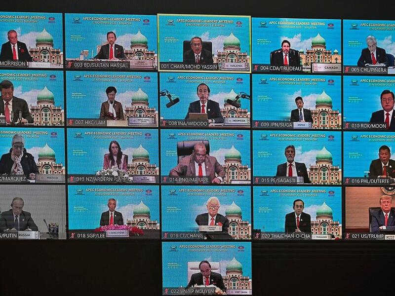 A screen shows the virtual meeting between world leaders, including US President Donald Trump (bottom R), Russian President Vladimir Putin (bottom L) and Chinese President Xi Jinping (L, second row from top), during the online Asia-Pacific Economic Cooperation (APEC) leaders' summit in Kuala Lumpur on November 20, 2020. MOHD RASFAN / AFP
