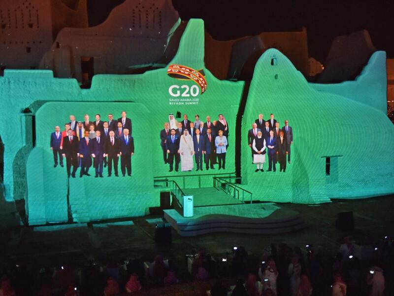 A family photo of G20 Leaders is projected at the historic site of al-Tarif in Diriyah district, on the outskirts of Saudi capital Riyadh, ahead of G20 virtual summit on November 20, 2020. FAYEZ NURELDINE / AFP