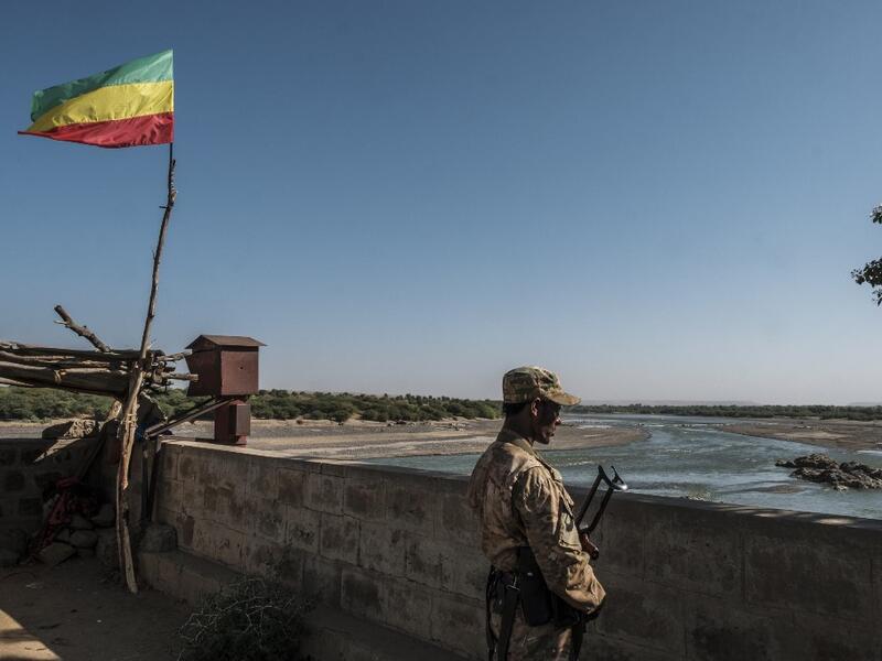 A member of the Amhara Special Forces watches on at the border crossing with Eritrea where an Imperial Ethiopian flag waves, in Humera, Ethiopia, on November 22, 2020. EDUARDO SOTERAS / AFP