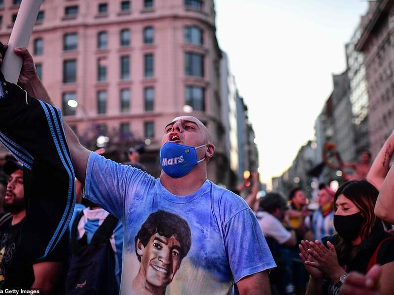 Fans of Argentinian football legend Diego Maradona gather by the Obelisk to pay homage on the day of his death in Buenos Aires. (AFP)