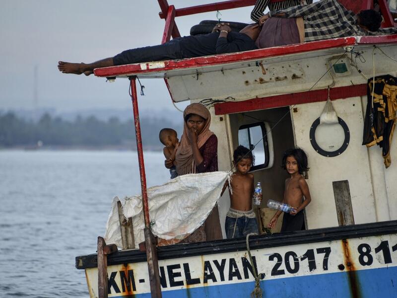 This photo taken on June 25, 2020 shows six-year-old Nosmin Fatima (R) with other Rohingya migrants as they arrive in Lhokseumawe in North Aceh. Weeks after a funeral for the wife and daughter he thought had died at sea while trying to sail to him, Nemah Shah was stunned when he saw online images of them emerging from a refugee boat in Indonesia.  CHAIDEER MAHYUDDIN / AFP