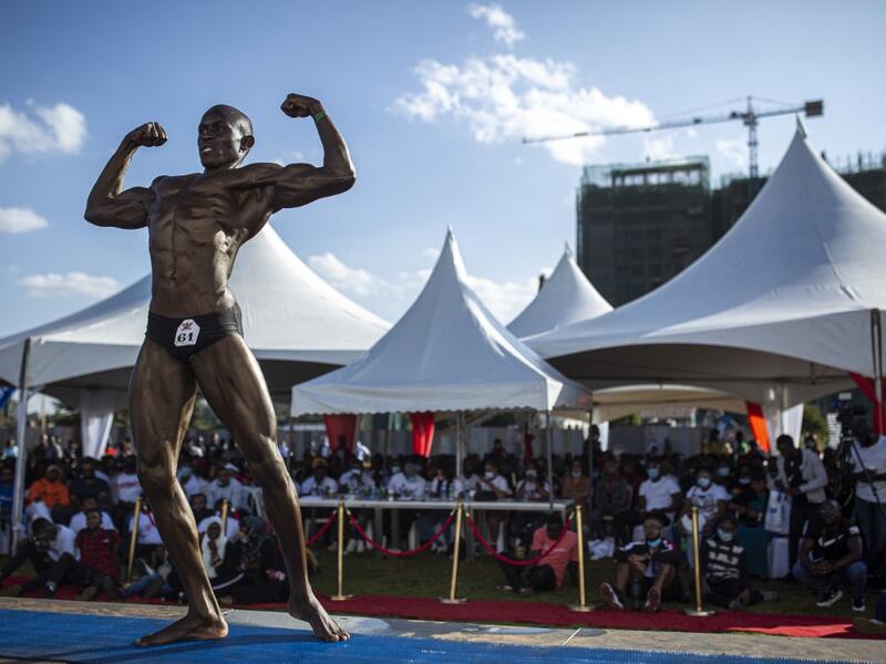 A bodybuilder poses on stage during the Iron Fit Bodybuilding competition in Nairobi on December 05, 2020. 130 participants from all across East Africa took part in the second edition of this competition which included categories like Bikini, Figure, Physique and Bodybuilding. Patrick Meinhardt / AFP
