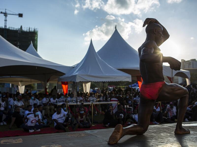 A bodybuilder poses on stage as he takes part in the Iron Fit Bodybuilding competition in Nairobi on December 05, 2020. 130 participants from all across East Africa took part in the second edition of this competition which included categories like Bikini, Figure, Physique and Bodybuilding. Patrick Meinhardt / AFP