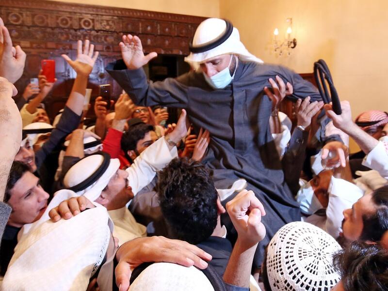 Kuwaiti candidate and Parliament Speaker Marzouq al-Ghanem celebrates with his supporters following the announcement of his victory in parliamentary election in Kuwait city, on December 6, 2020. Unlike other oil-rich Gulf states, Kuwait has a lively political life and its parliament, elected for four-year terms, enjoys wide legislative powers. Political disputes are often fought in public. But with more than 144,000 novel coronavirus cases to date, including 889 deaths, the election campaign has been toned 