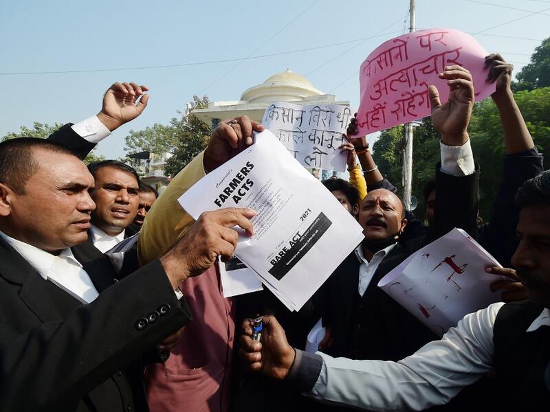 Members of All India lawyers union prepare to burn a copy of the Farmers Acts during a protest in support of the nationwide general strike called by farmers against the recent agricultural reforms in Allahabad on December 8, 2020.  SANJAY KANOJIA / AFP