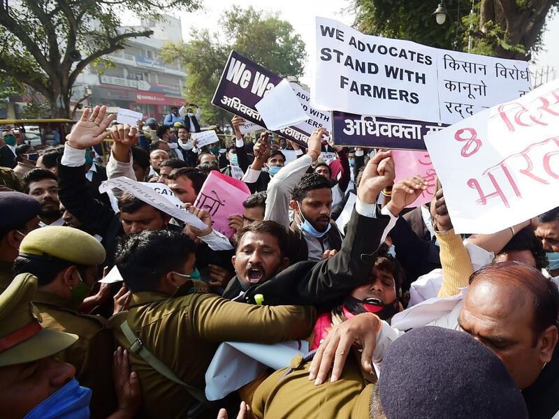 Members of All India lawyers union scuffle with police during a protest in support of the nationwide general strike called by farmers against the recent agricultural reforms in Allahabad on December 8, 2020. SANJAY KANOJIA / AFP