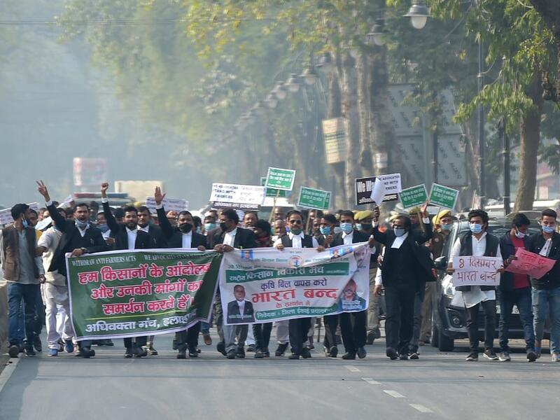 Members of All India lawyers union Acts march along a street during a protest in support of the nationwide general strike called by farmers against the recent agricultural reforms in Allahabad on December 8, 2020. SANJAY KANOJIA / AFP