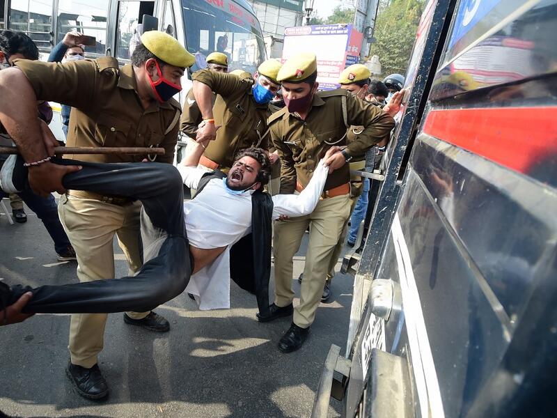 Policemen detain a student leader during a protest in support of the nationwide general strike called by farmers against the recent agricultural reforms in Allahabad on December 8, 2020. SANJAY KANOJIA / AFP