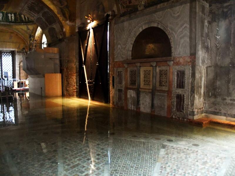 A view shows the flooded entrance of St. Mark's Basilica on December 8, 2020 in Venice following a high tide "Alta Acqua" event following heavy rains and strong winds, and the mobile gates of the MOSE Experimental Electromechanical Module that protects the city of Venice from floods, were not lifted ANDREA PATTARO / AFP