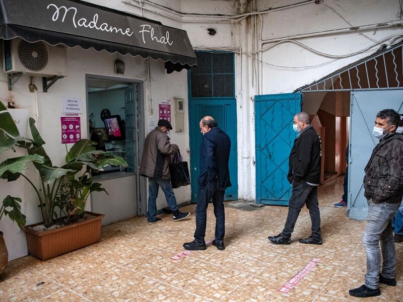 Moroccan Jewish and Muslim men queue in front of the kosher bakery 'Madame Khal' in the western Moroccan port city of Casablanca, on December 11, 2020 After the United Arab Emirates, Bahrain and Sudan, Morocco is the fourth Arab country since August to commit to establishing diplomatic relations with the Israel. In the 1950s and 60s, Jews from Iraq, Yemen and Morocco migrated to the Jewish state, where key posts were in the hands of Ashkenazi Jews, who hail from Europe. FADEL SENNA / AFP