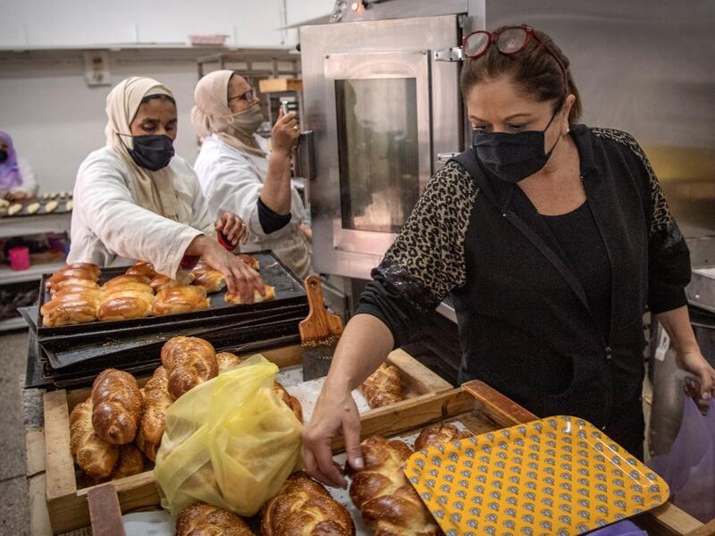 A Moroccan Jewish woman (R) fills bags with pastries to serve customers at the kosher bakery 'Madame Fhal' in the western Moroccan port city of Casablanca, on December 11, 2020 After the United Arab Emirates, Bahrain and Sudan, Morocco is the fourth Arab country since August to commit to establishing diplomatic relations with the Israel. In the 1950s and 60s, Jews from Iraq, Yemen and Morocco migrated to the Jewish state, where key posts were in the hands of Ashkenazi Jews, who hail from Europe. FADEL SENNA