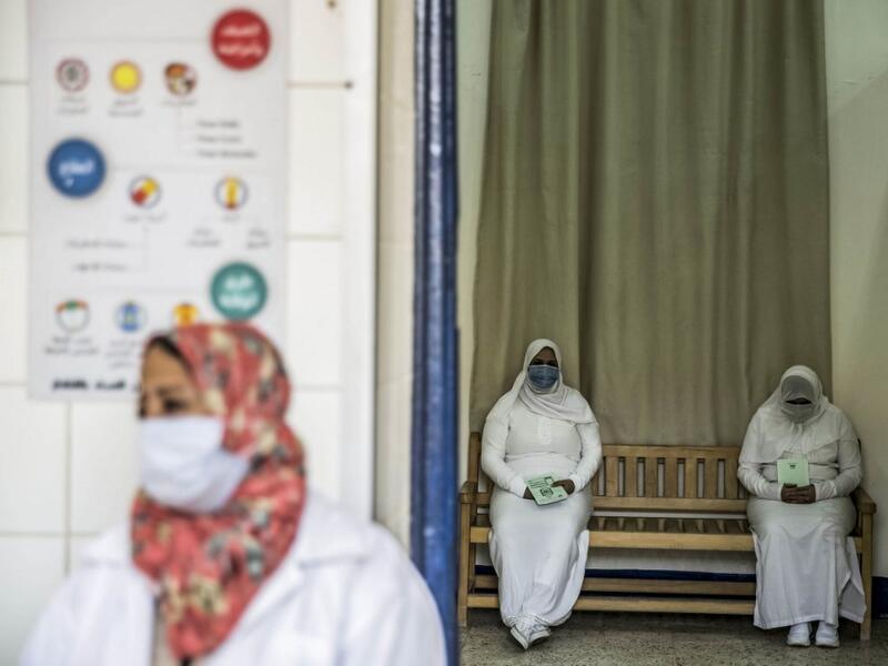 This picture taken during a government-guided tour on December 27, 2020 shows inmates, mask-clad due to the COVID-19 coronavirus pandemic, waiting at the outpatient clinic at al-Qanatir women's prison, at the tip of the Nile delta in Qalyoubiya province, about 30 kilometres north of Egypt's capital. Khaled DESOUKI / AFP