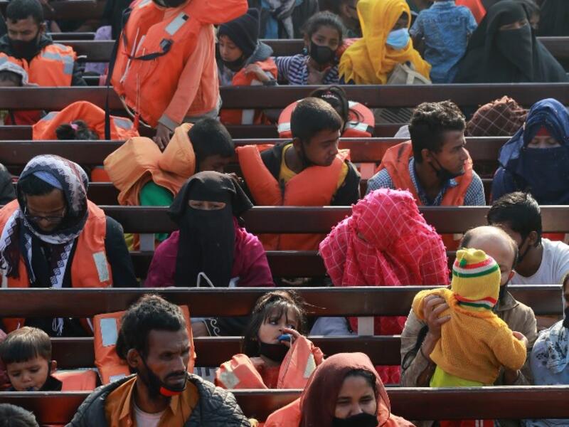 Rohingya refugees sit on a Bangladesh Navy ship as they are relocated to the controversial flood-prone island Bhashan Char in the Bay of Bengal, in Chittagong on December 29, 2020. Rehman ASAD / AFP