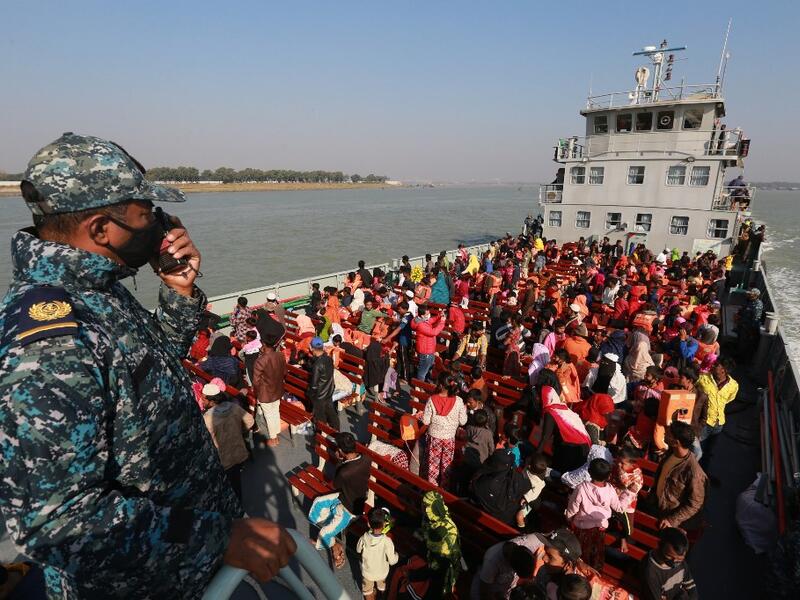 Rohingya refugees sit on a Bangladesh Navy ship as they are relocated to the controversial flood-prone island Bhashan Char in the Bay of Bengal, in Chittagong on December 29, 2020. Rehman ASAD / AFP